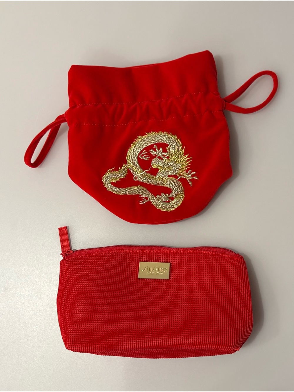 Shiseido Red Cosmetic Zip cosmetic bag, Estee Louder pouch.